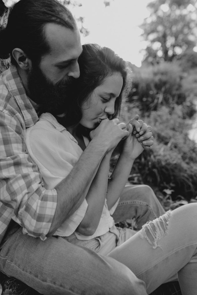 Female is kissing her partner. they are cuddling close. Hampshire couple's photographer. Natural and relaxed photo session in Hampshire. Ewa Jones Photography
