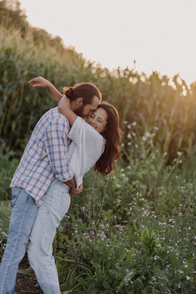Couple is standing in the field of corn and enjoying Hampshire country side. Hampshire photographer. Ewa Jones Photography