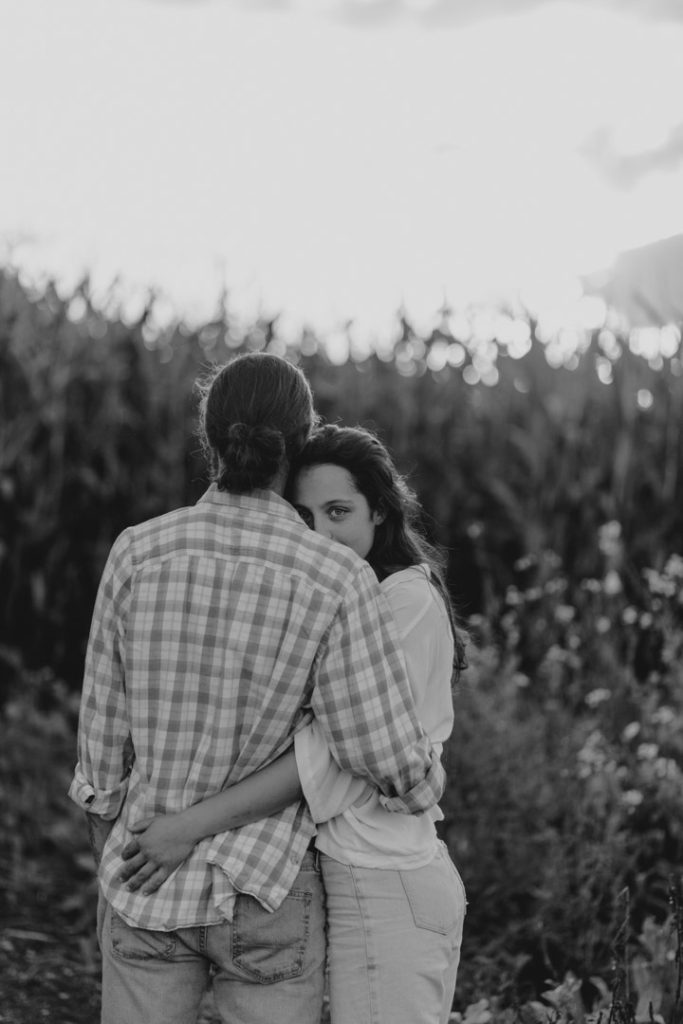 Couple is standing in the field of corn and enjoying Hampshire country side. Hampshire photographer. Ewa Jones Photography