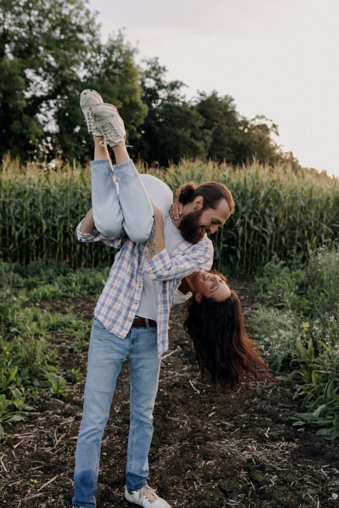Female is being lifted by her partner. She is laughing. Hampshire photographer. Basingstoke photo session. Ewa Jones Photography