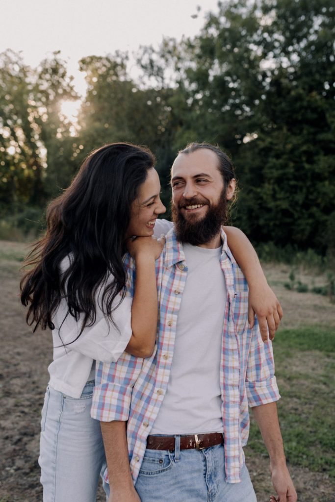 Couple is enjoying being outside. They are wearing lovely natural clothes. Natural couple photo shoot in Hampshire. Ewa Jones Photography