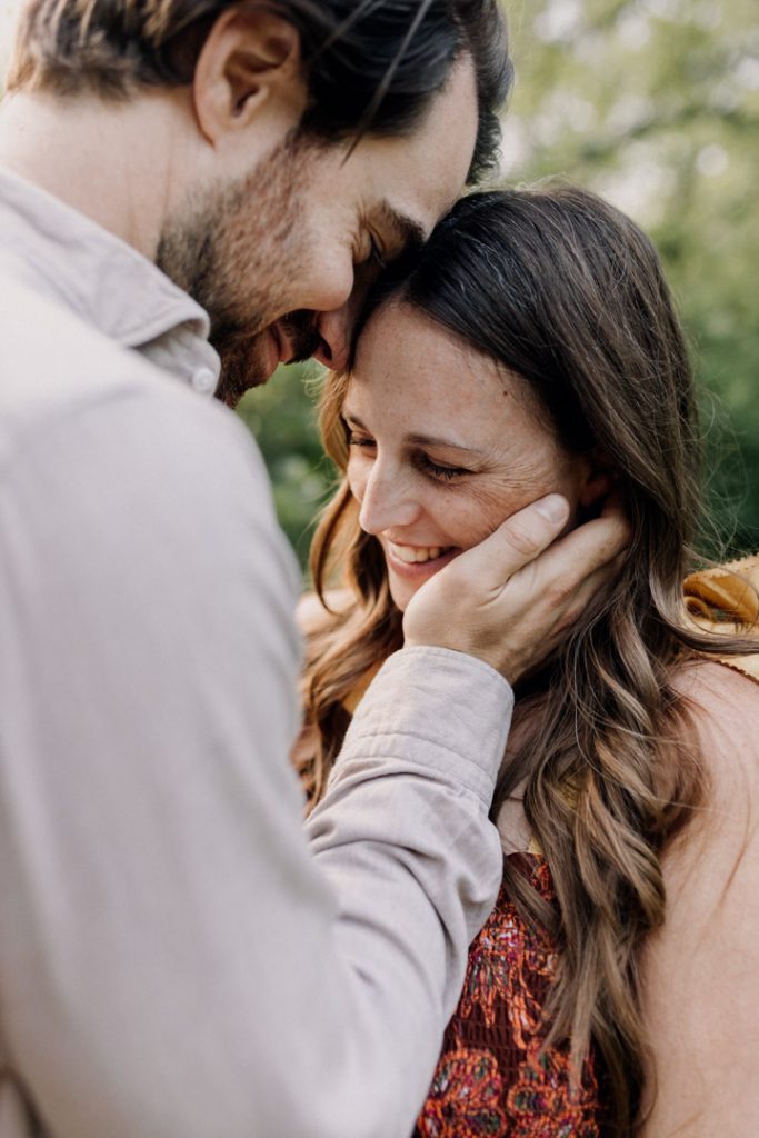 Mum is laughing and dad to be is looking at his wife. Bump photo session. Hampshire photographer. Ewa Jones Photographer