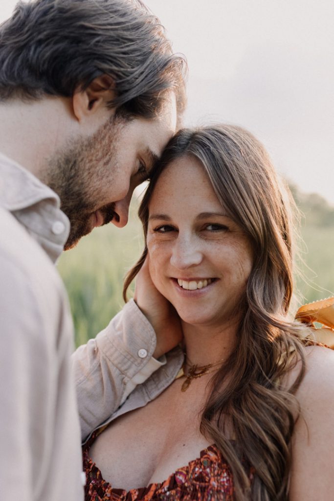 Mum is looking at the camera and dad to be is looking at his wife. Bump photo session. Hampshire photographer. Ewa Jones Photographer