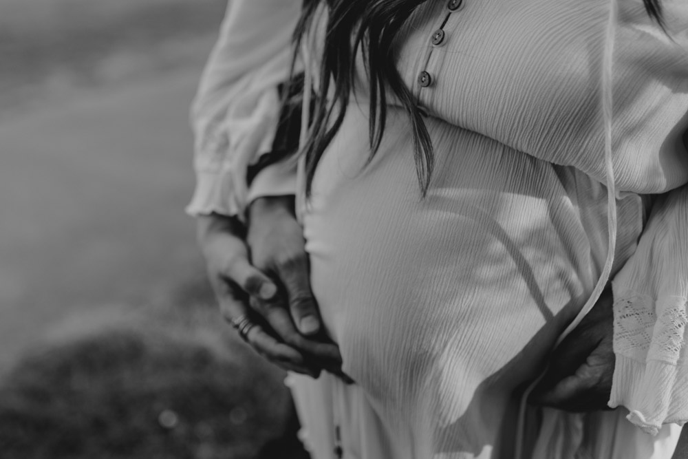 mum and dad are holding baby bump. maternity and pregnancy photo session by Hampshire based photographer. Ewa Jones Photographer