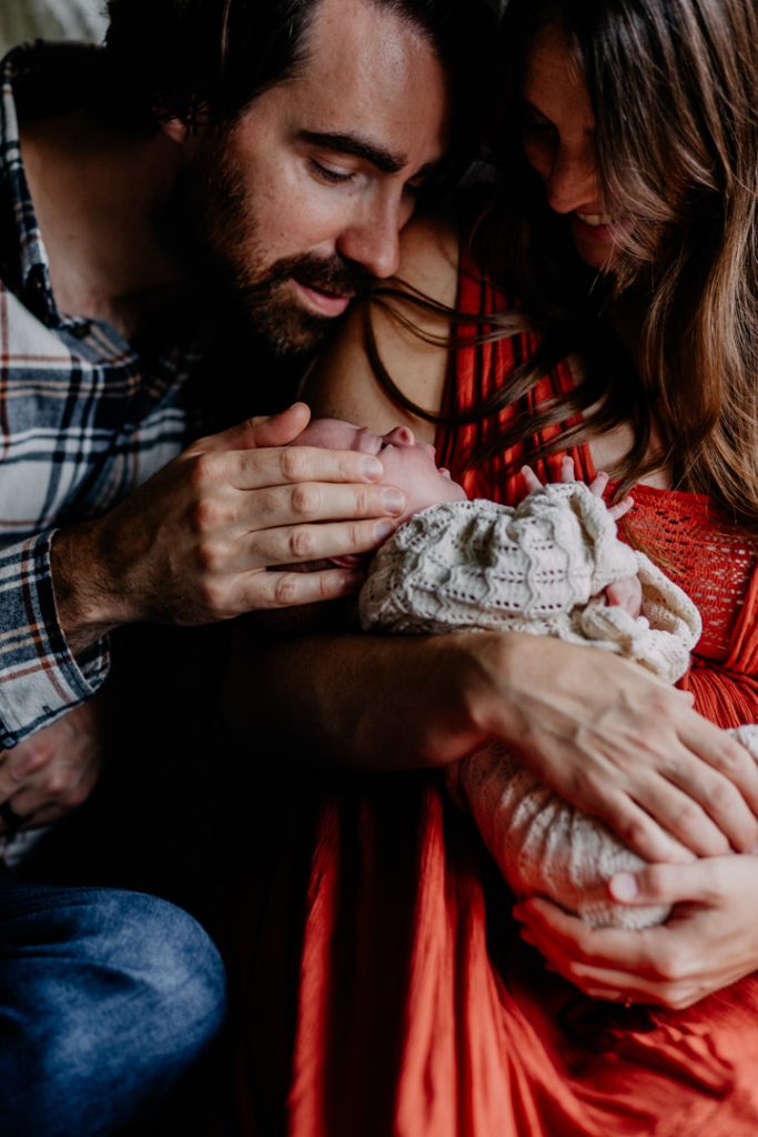 lovely cropped image of parents tending to their newborn baby girl. lovely in home newborn photo session. Hampshire photo shoot. Ewa Jones Photography
