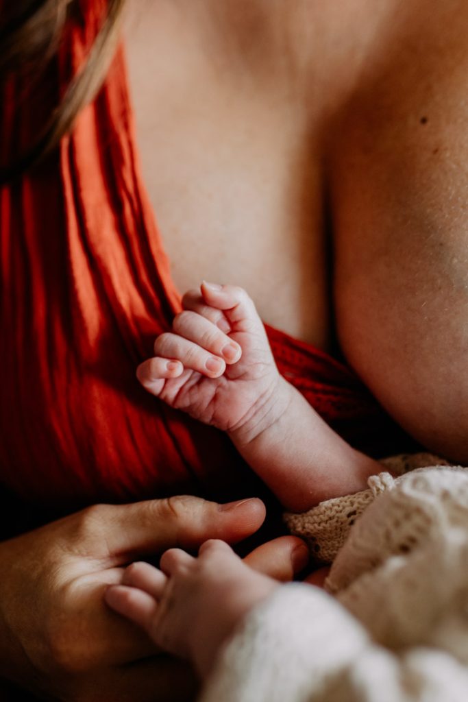 Lovely close up image of mum holding her newborn baby and it is a close up of newborn baby's hand. Hampshire newborn photo shoot. Hampshire photographer. Ewa Jones Photography