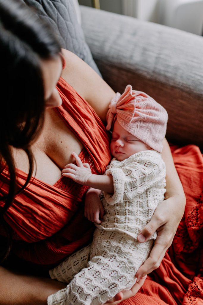 Close up image of new mum holding her baby girl and looking down at her. Baby girl is sleeping. Hampshire photo shoot. Hampshire photographer. Ewa Jones Photography