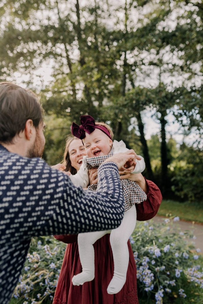 Mum is lifting her baby girl up in the air. outdoor natural session. Hampshire family photographer. Ewa Jones Photography