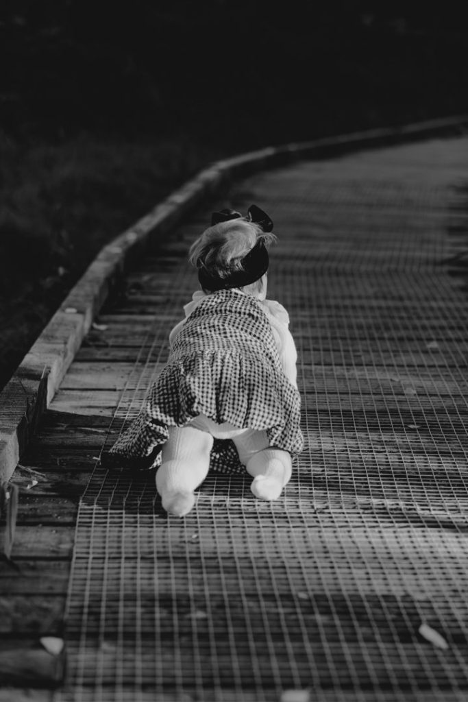 Black and white image of one year old girl walking on her fours. celebrating one year old. Hampshire photo shoot. Ewa Jones Photography