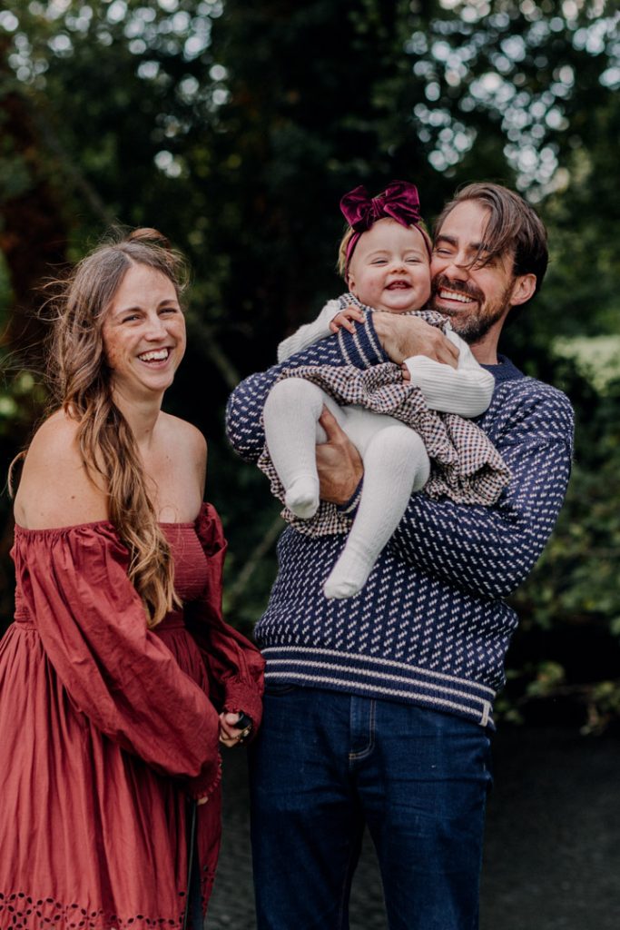 Family of three is all smiling. little girl is laughing. lovely celebration of a girl. one year old photo shoot. Hampshire family photographer. Ewa Jones Photographer
