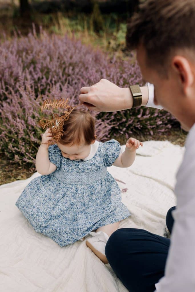 Dad is teasing his girl with a fern. she is smiling and likes being tickled. Lovely photo shoot to create memories lasting life time. Photo shoot in the nature. Hampshire family photographer. Ewa Jones photography