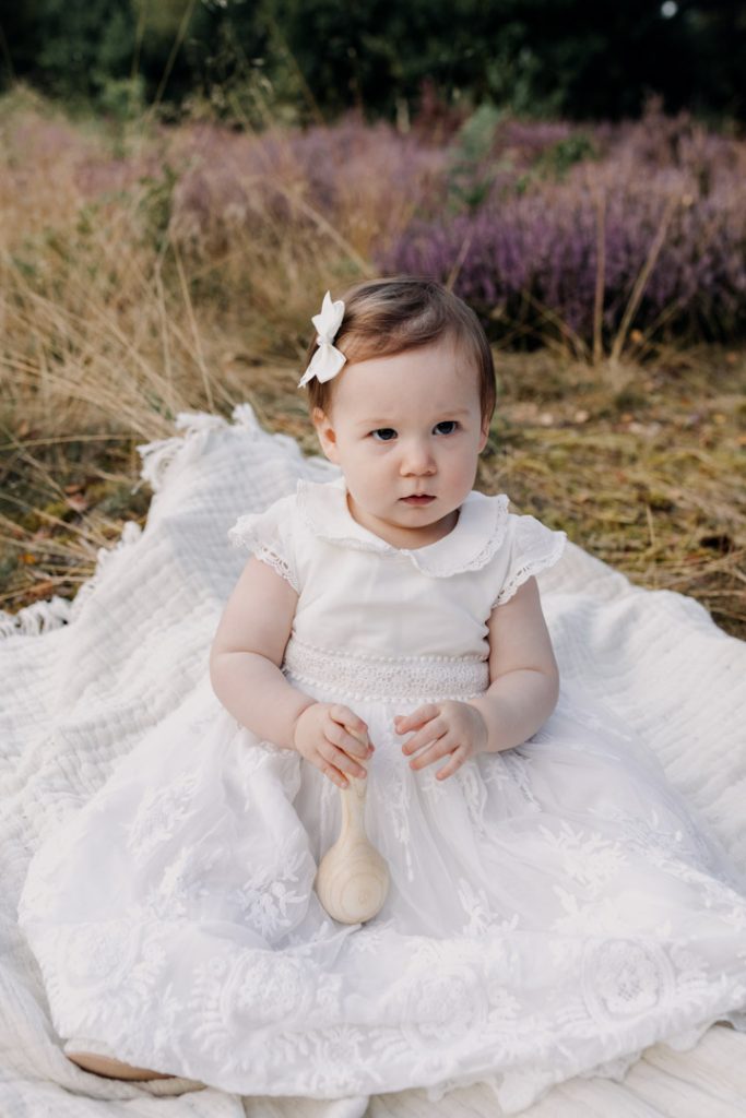 Little one year old girl wearing beautiful white dress. Hampshire family photo shoot. Ewa Jones Photography