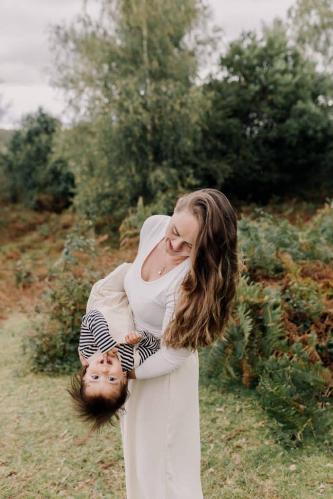 Mum is lifting her son upside down. fun family photo session in Hampshire. new forest photo shoot. Family photographer. Ewa Jones Photography