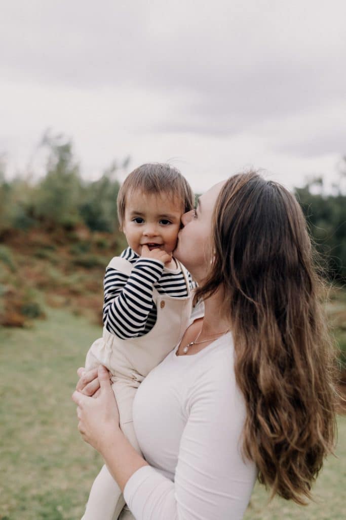 Mum is kissing her son in his cheek. lovely natural family photo session in Hampshire. Hampshire photographer. Ewa Jones Photography