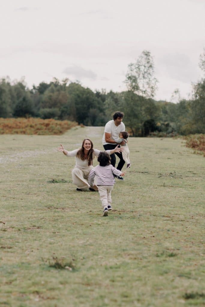 Boy is running to his mum and mum is smiling back to him. natural family photo session in Hampshire. New forest photo shoot. Ewa Jones Photography