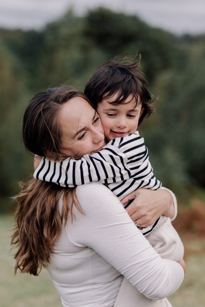 Mum is cuddling her son. lovely natural and simple photo session. delicate and lovely moments with child and parent. Ewa Jones Photography. Hampshire family photographer