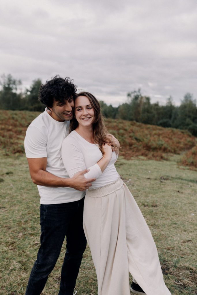 Mum is leaning towards dad and smiling. Man is smiling too. Couple photo shoot. fun natural unposed photo session. Hampshire family photographer. Ewa Jones Photography