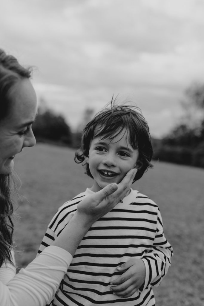 mum is touching her son cheek. Natural poses during family photo session. Basingstoke photographer. Ewa Jones Photography