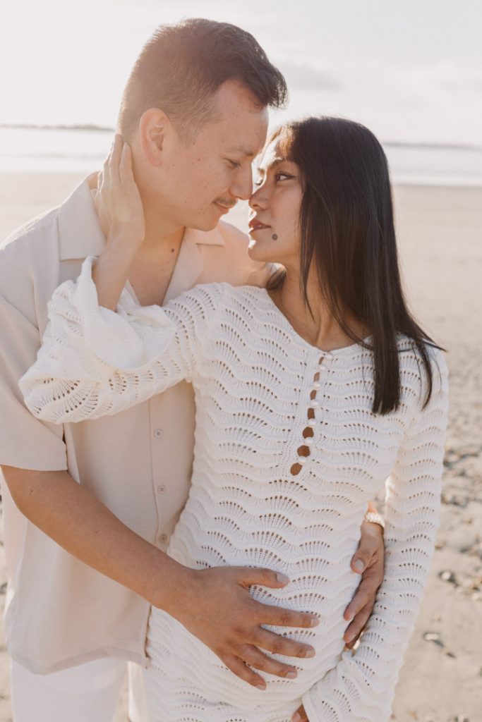 parents to be are cuddling close. Maternity photo ideas. maternity poses. Hampshire maternity photographer. Ewa Jones Photography