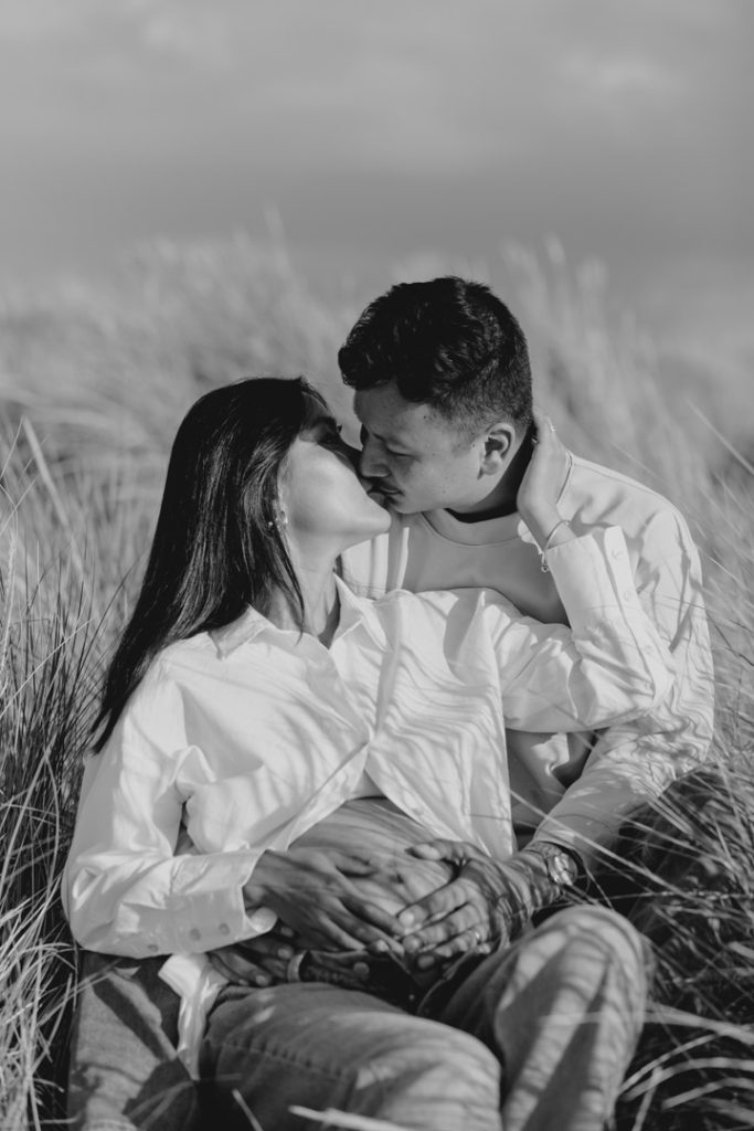 Expecting parents are cuddling and kissing. maternity photo session. Hampshire family photographer. Ewa Jones Photography