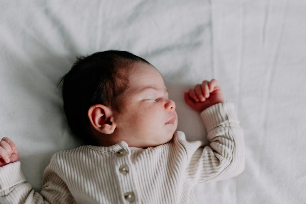 baby is sleeping on the bed. Hampshire newborn photo shoot. Newborn photography. Ewa Jones Photography